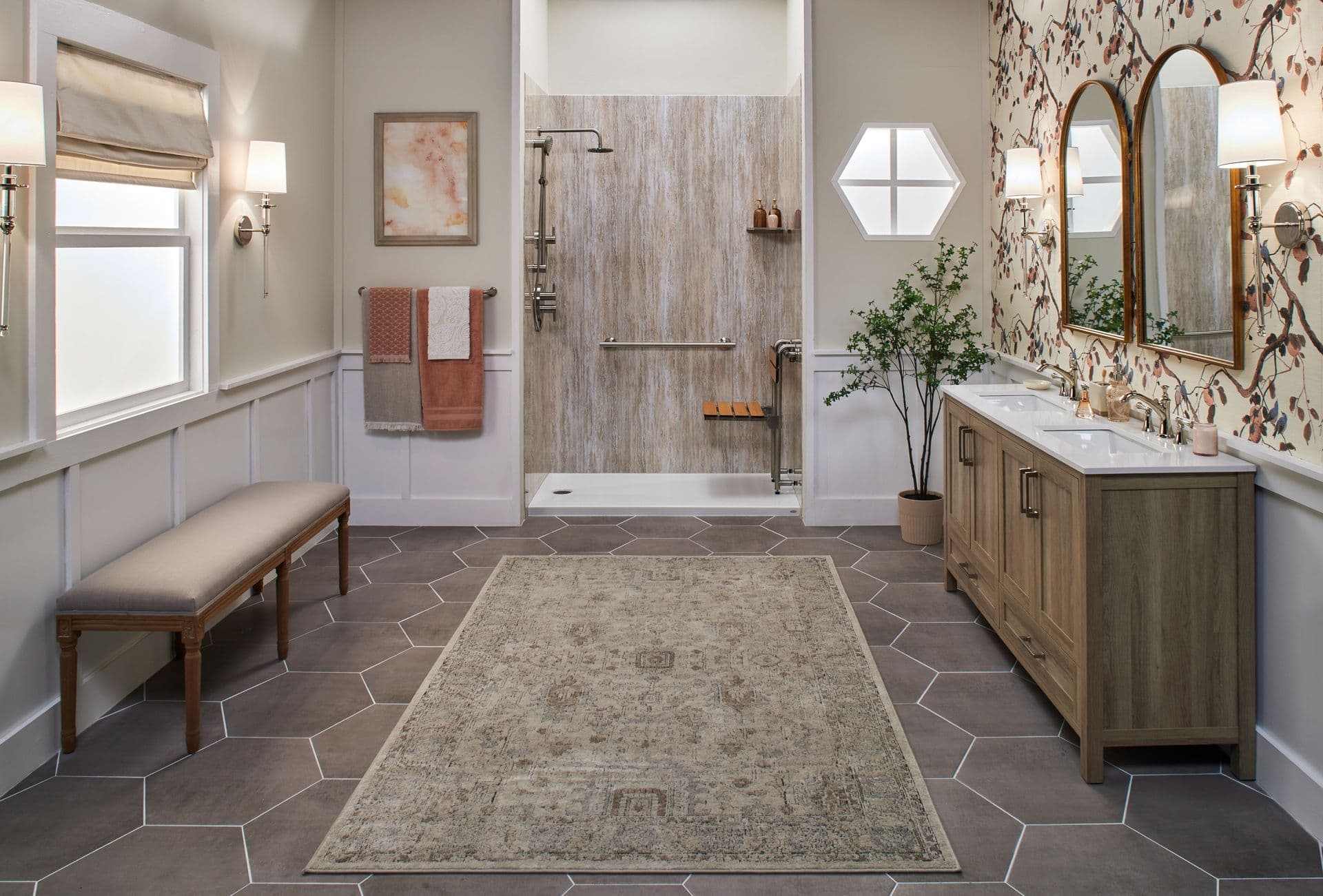 Remodeled bathroom with a bench, patterned rug, and wood vanity